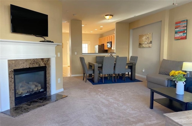 living room featuring light carpet and a premium fireplace