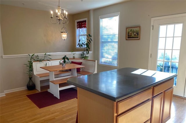 dining room with a notable chandelier and light wood-type flooring