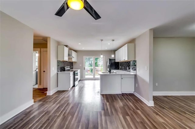 kitchen featuring backsplash, white cabinetry, dark hardwood / wood-style floors, and appliances with stainless steel finishes