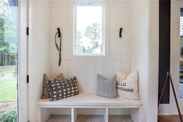 mudroom featuring a decorative wall and wainscoting