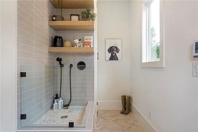 laundry room featuring baseboards and wood finished floors