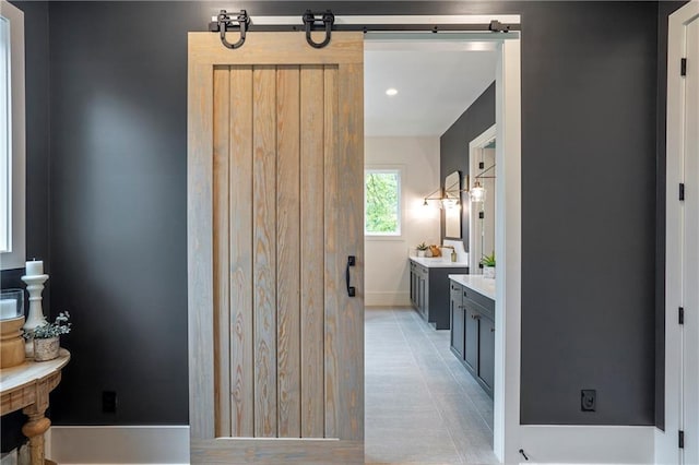 full bath featuring vanity and baseboards