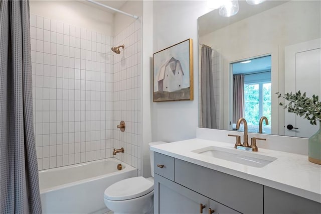 bathroom featuring vanity, shower / bathtub combination with curtain, and toilet