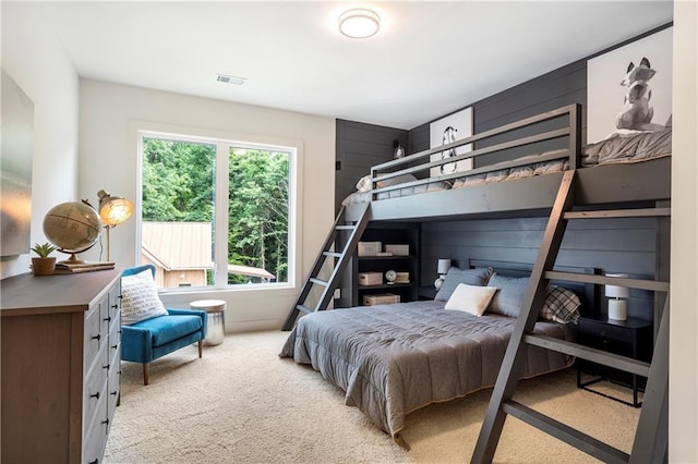 bedroom featuring visible vents and light carpet