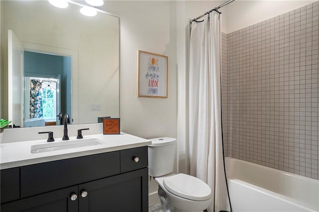 bathroom with vanity, shower / bathtub combination with curtain, and toilet