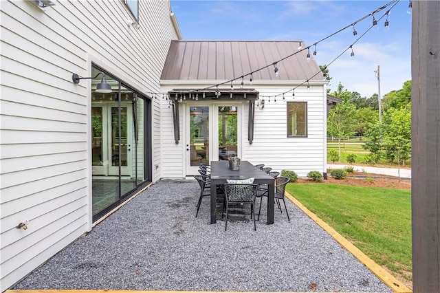 rear view of house featuring fence, a yard, a patio area, and metal roof