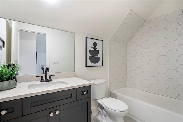 full bath featuring vanity, vaulted ceiling, toilet, and shower / washtub combination