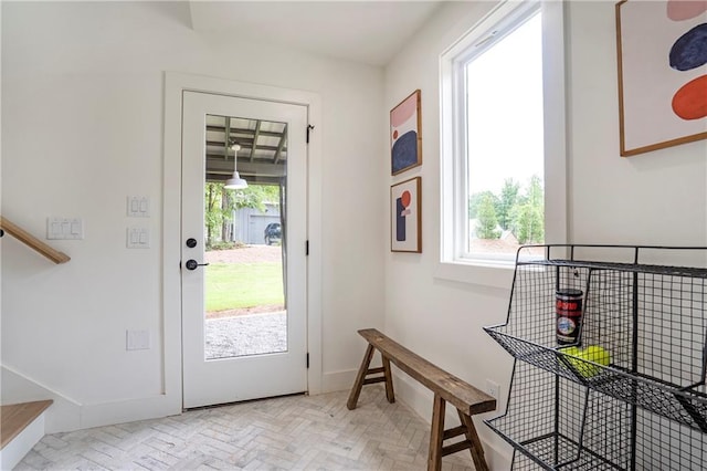 doorway to outside featuring baseboards