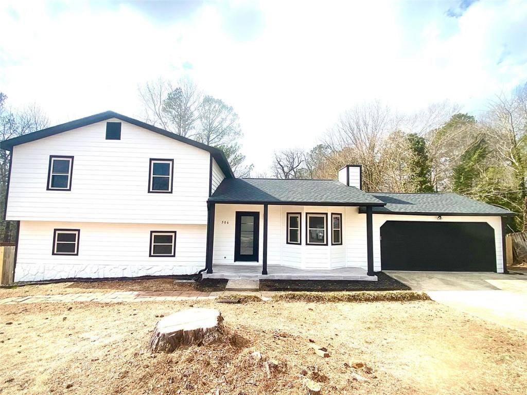 split level home featuring a garage and a porch