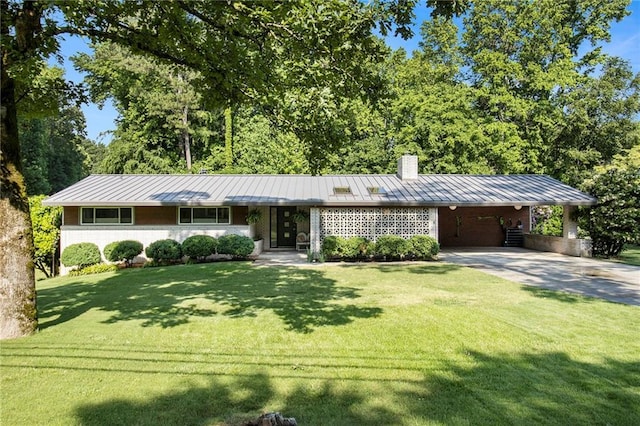 4020 N Cooper Lake Rd SE, Smyrna, GA 30082 - view of front facade with a standing seam roof, a chimney, driveway, and a front lawn