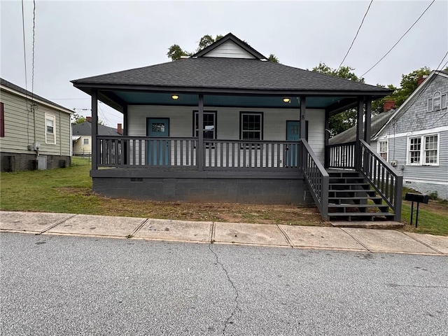 8 Hazel St, Porterdale, GA 30014 - shotgun-style home with a porch and a shingled roof