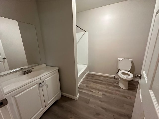 8 Hazel St, Porterdale, GA 30014 - full bath with toilet, vanity, wood finished floors, baseboards, and shower / washtub combination