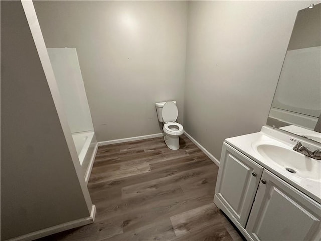 8 Hazel St, Porterdale, GA 30014 - bathroom with toilet, vanity, wood finished floors, and baseboards