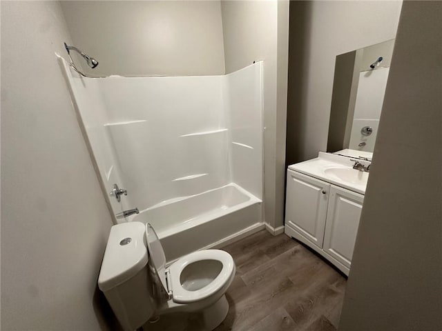 8 Hazel St, Porterdale, GA 30014 - bathroom featuring toilet, wood finished floors, washtub / shower combination, and vanity