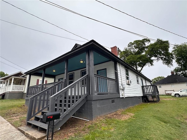 8 Hazel St, Porterdale, GA 30014 - view of home's exterior with crawl space, a lawn, a chimney, and a porch