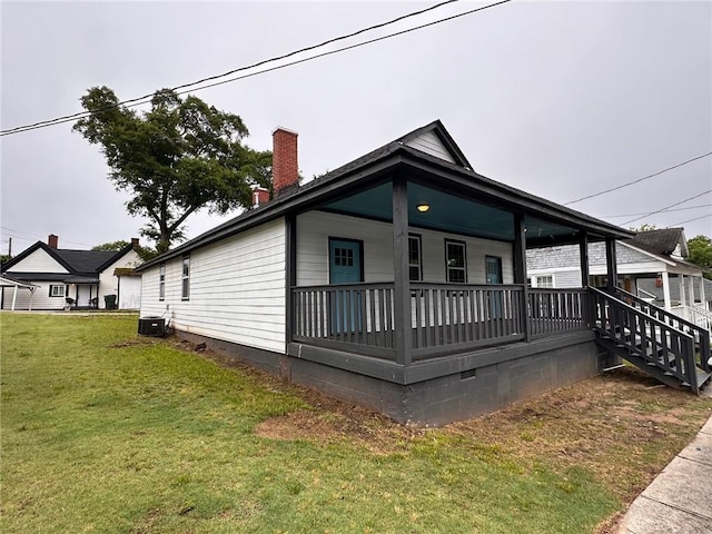 8 Hazel St, Porterdale, GA 30014 - view of home's exterior featuring a yard, a chimney, a porch, and central AC