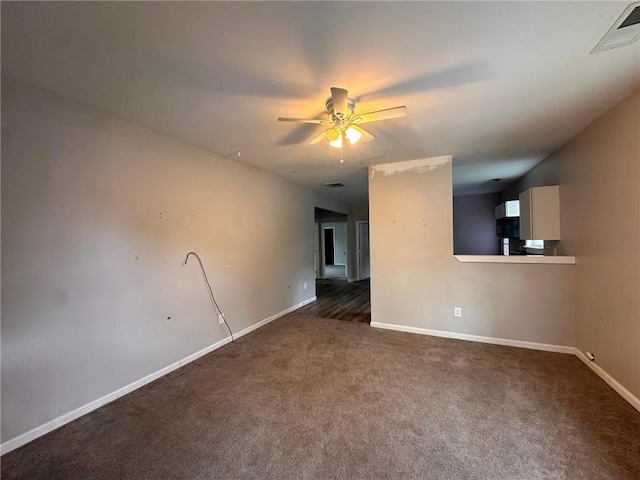 8 Hazel St, Porterdale, GA 30014 - empty room with dark colored carpet, a ceiling fan, and baseboards