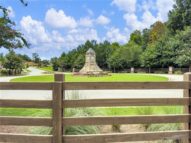 view of gate with a lawn