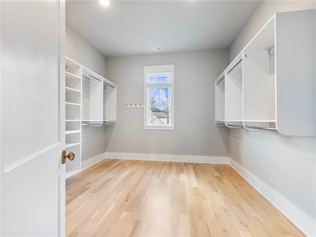 spacious closet featuring light hardwood / wood-style floors