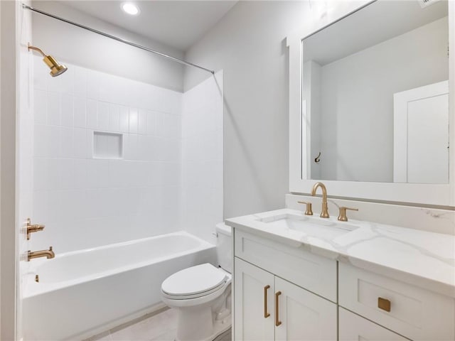 full bathroom featuring tile patterned flooring, toilet, vanity, and tiled shower / bath