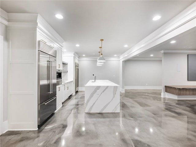 kitchen with a kitchen island with sink, stainless steel built in fridge, light stone counters, white cabinetry, and decorative light fixtures