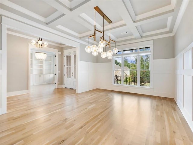 unfurnished dining area with built in features, a notable chandelier, light hardwood / wood-style floors, and coffered ceiling