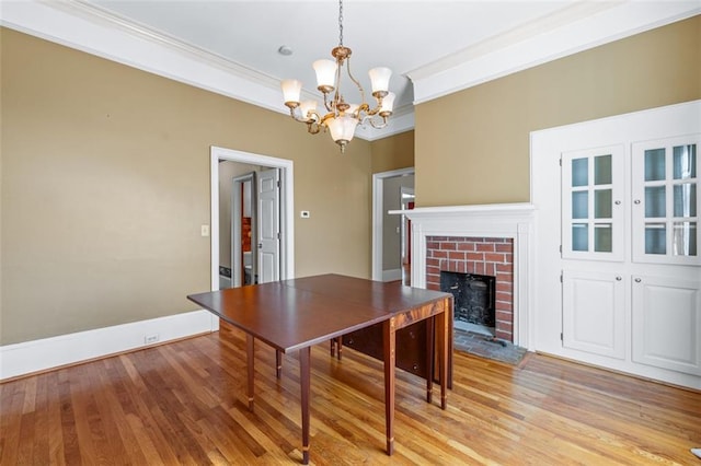 150 E Main St, Rutledge, GA 30663 - dining area with a chandelier, light wood-type flooring, a fireplace, ornamental molding, and baseboards