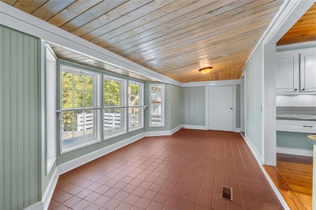 unfurnished sunroom featuring wood ceiling and lofted ceiling