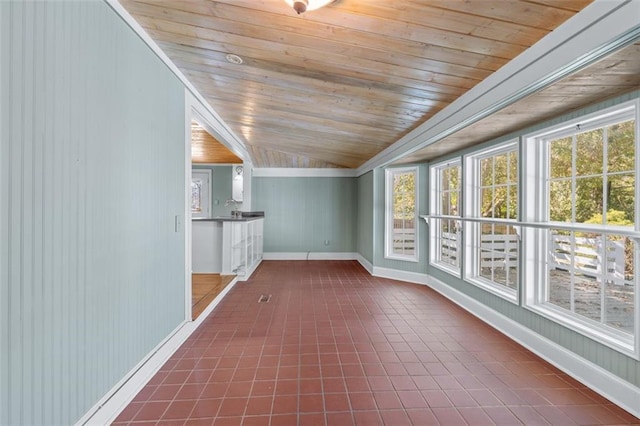 unfurnished sunroom featuring lofted ceiling and wood ceiling