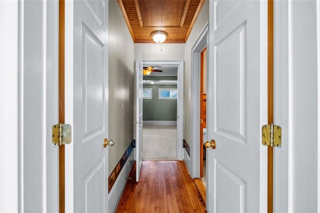 hall featuring wooden ceiling and hardwood / wood-style floors