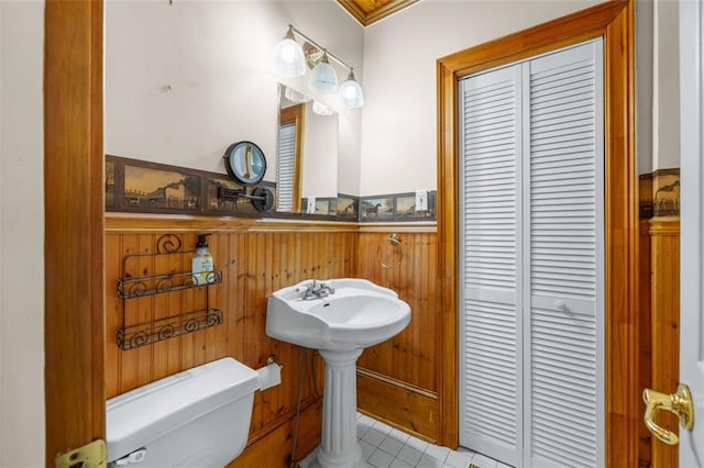 150 E Main St, Rutledge, GA 30663 - half bathroom with toilet, wainscoting, tile patterned flooring, wood walls, and ornamental molding
