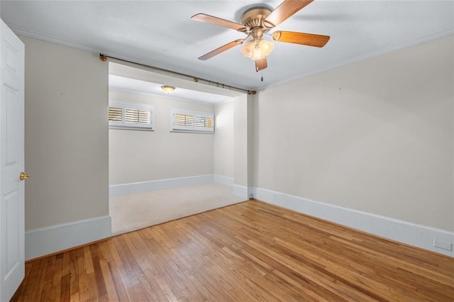 empty room featuring ceiling fan, ornamental molding, and hardwood / wood-style floors