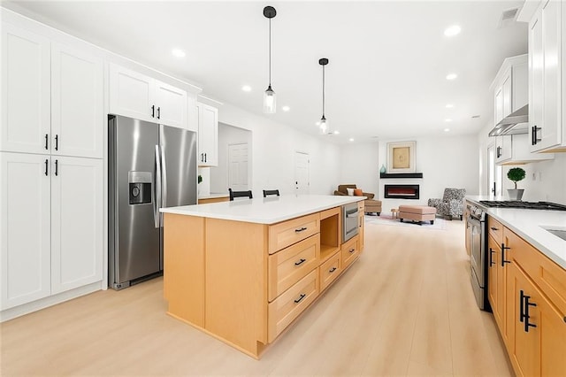 3684 Clearbrooke Way, Duluth, GA 30097 - kitchen with appliances with stainless steel finishes, light wood-type flooring, a warm lit fireplace, recessed lighting, and pendant lighting