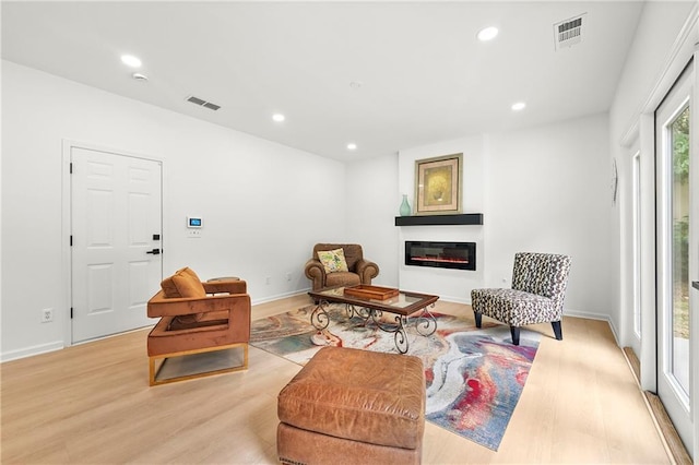 3684 Clearbrooke Way, Duluth, GA 30097 - living area with light wood finished floors, a glass covered fireplace, recessed lighting, and baseboards