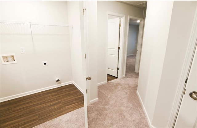 laundry area with hookup for a washing machine, carpet floors, wood finished floors, baseboards, and electric dryer hookup