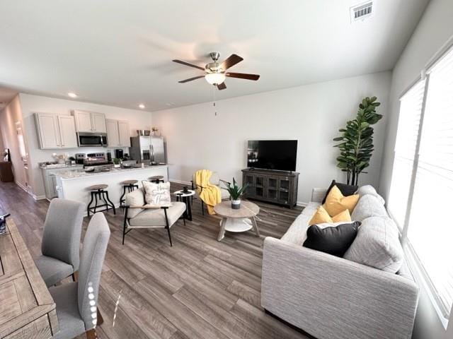 living room featuring visible vents, dark wood finished floors, baseboards, ceiling fan, and recessed lighting