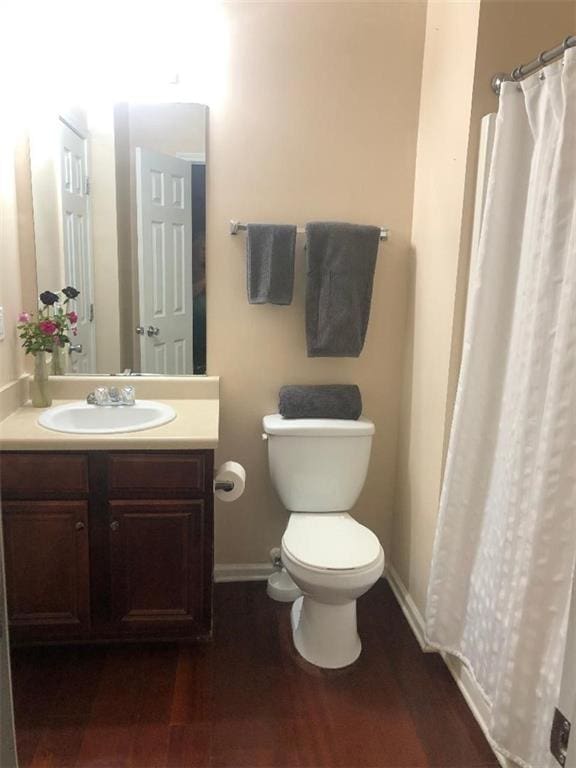 3554 Umatilla Ln SW, South Fulton, GA 30331 - bathroom featuring toilet, vanity, baseboards, wood finished floors, and curtained shower