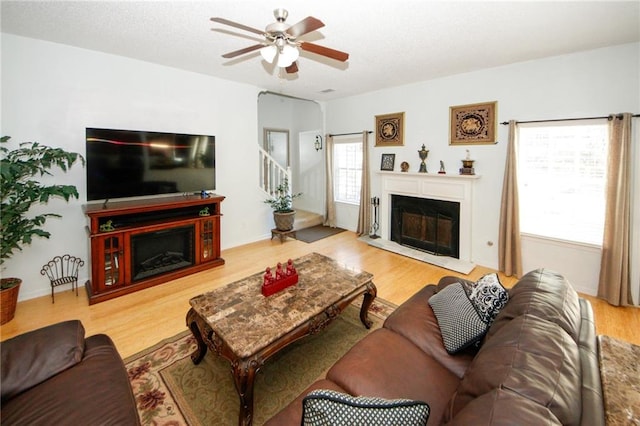 3554 Umatilla Ln SW, South Fulton, GA 30331 - living area featuring a fireplace, wood finished floors, and a ceiling fan