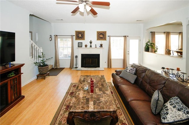 3554 Umatilla Ln SW, South Fulton, GA 30331 - living room with wood finished floors, a ceiling fan, stairs, and a glass covered fireplace