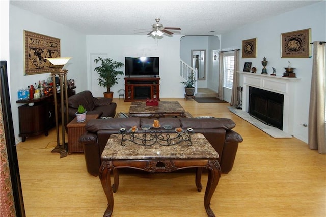 3554 Umatilla Ln SW, South Fulton, GA 30331 - living area with a fireplace, wood finished floors, a ceiling fan, a textured ceiling, and stairway