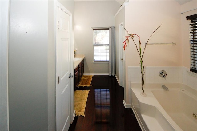 3554 Umatilla Ln SW, South Fulton, GA 30331 - full bathroom with a bath, vanity, baseboards, and wood finished floors