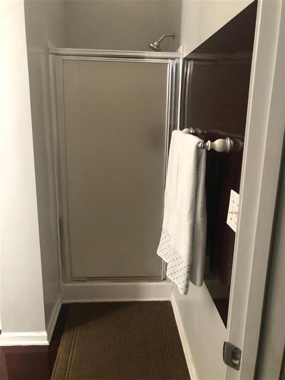 3554 Umatilla Ln SW, South Fulton, GA 30331 - bathroom featuring a stall shower and baseboards