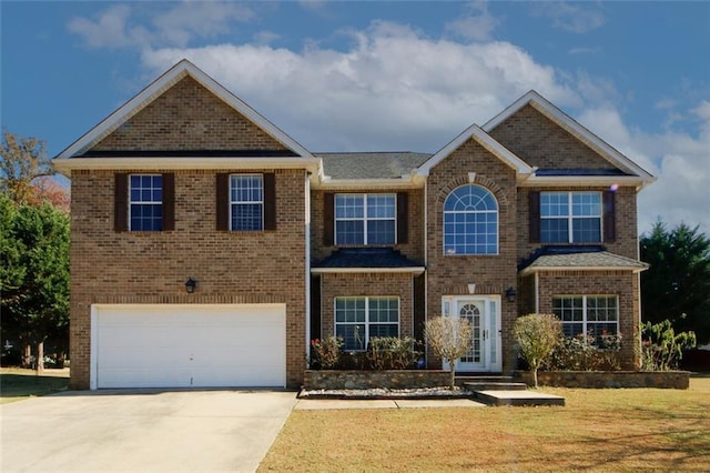3554 Umatilla Ln SW, South Fulton, GA 30331 - view of front of house with driveway, an attached garage, brick siding, and a front lawn