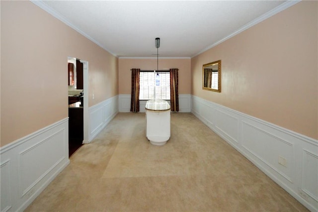 3554 Umatilla Ln SW, South Fulton, GA 30331 - unfurnished dining area with a decorative wall, a wainscoted wall, crown molding, and light colored carpet