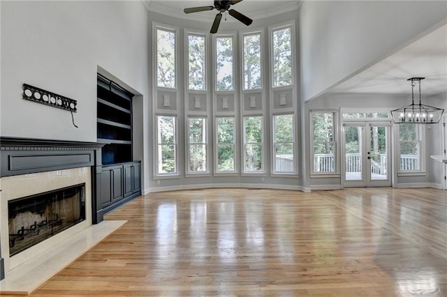 1723 Woodbow Path, Dacula, GA 30019 - unfurnished living room featuring a fireplace, ceiling fan, healthy amount of natural light, light wood-type flooring, and a high ceiling