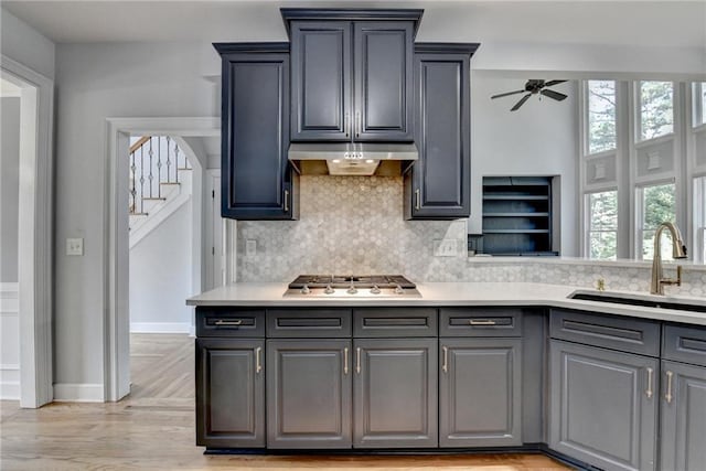 1723 Woodbow Path, Dacula, GA 30019 - kitchen featuring stainless steel gas cooktop, exhaust hood, healthy amount of natural light, and light countertops