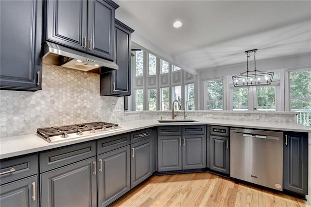 1723 Woodbow Path, Dacula, GA 30019 - kitchen with stainless steel appliances, light countertops, tasteful backsplash, under cabinet range hood, and recessed lighting