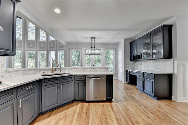 1723 Woodbow Path, Dacula, GA 30019 - kitchen featuring stainless steel dishwasher, a peninsula, tasteful backsplash, light wood finished floors, and light countertops