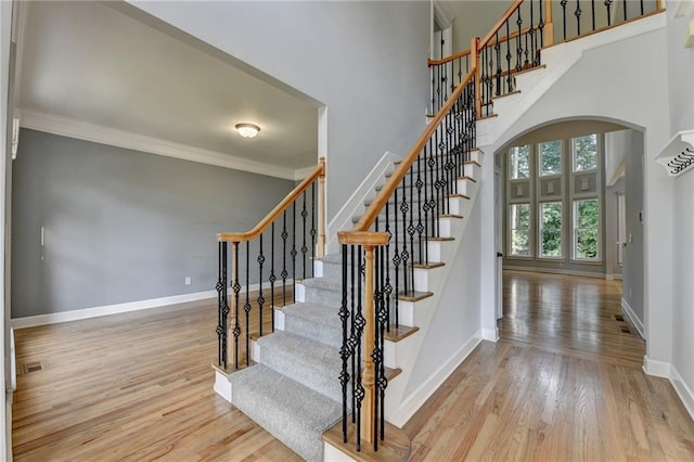 1723 Woodbow Path, Dacula, GA 30019 - stairway featuring wood finished floors, arched walkways, ornamental molding, and a high ceiling