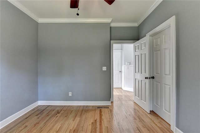 1723 Woodbow Path, Dacula, GA 30019 - unfurnished bedroom with crown molding, light wood-type flooring, and a ceiling fan